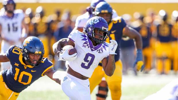 Oct 29, 2022; Morgantown, West Virginia, USA; TCU Horned Frogs running back Emani Bailey (9) runs the ball for a touchdown during the second quarter against the West Virginia Mountaineers at Mountaineer Field at Milan Puskar Stadium. Mandatory Credit: Ben Queen-USA TODAY Sports